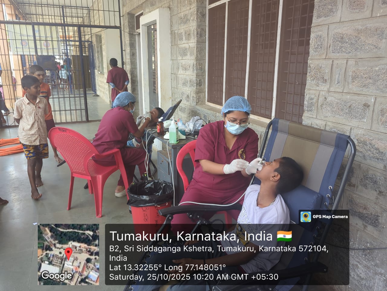 Dentist performing oral prophylaxis on a student on Day 2